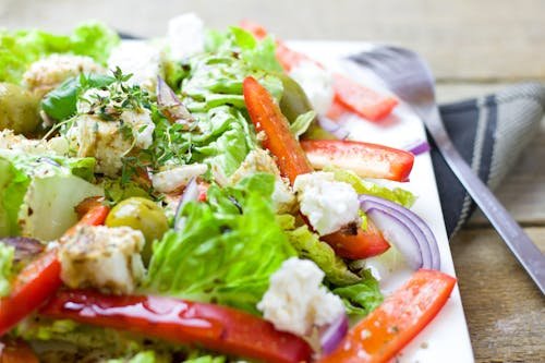 Free Colorful Greek salad with fresh vegetables and feta cheese. Stock Photo